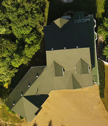Inspecting shingles on the roof of a residential building using a multirotor drone ( Unmanned Aerial Vehicle )