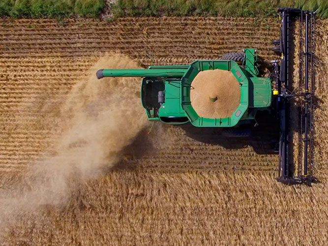 Aerial image of combine harvesting durum wheat from a field near Swift Current, Saskatchewan, Canada